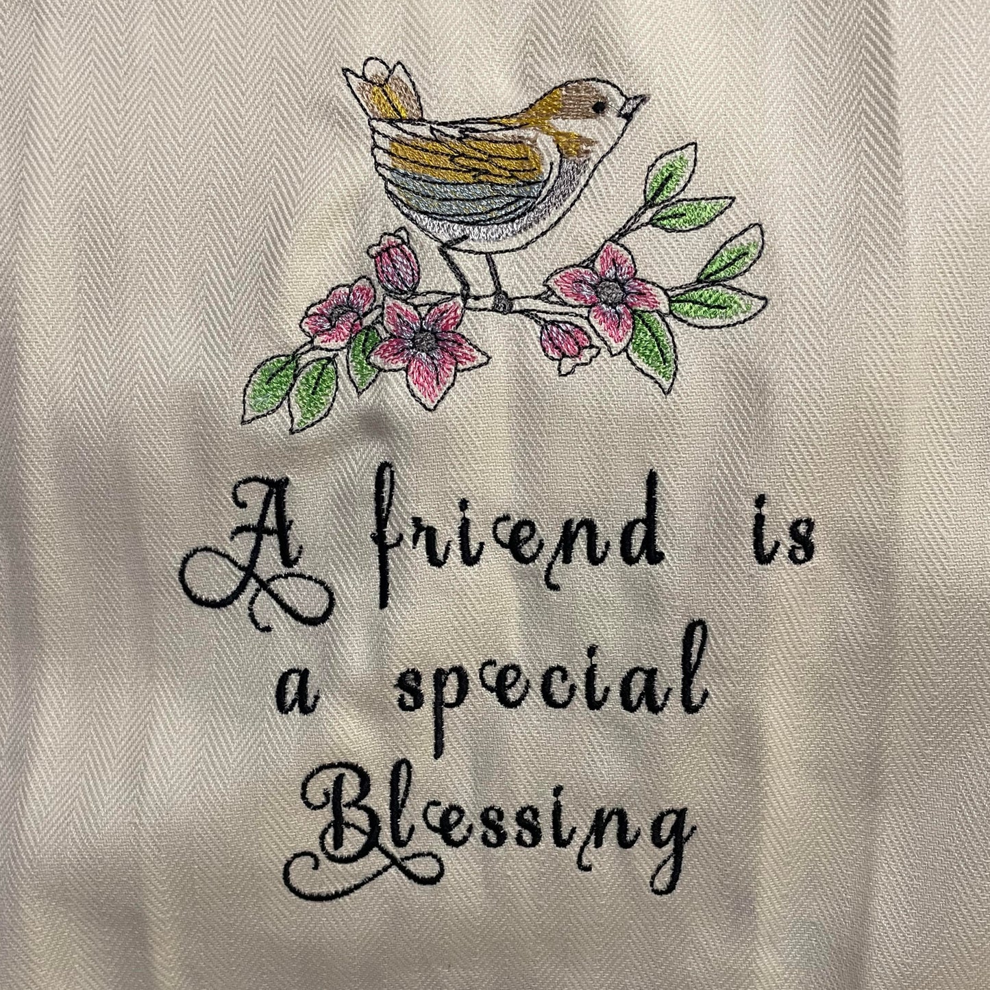 dish towel displaying the phrase "a friend is a special blessing" with a bird.