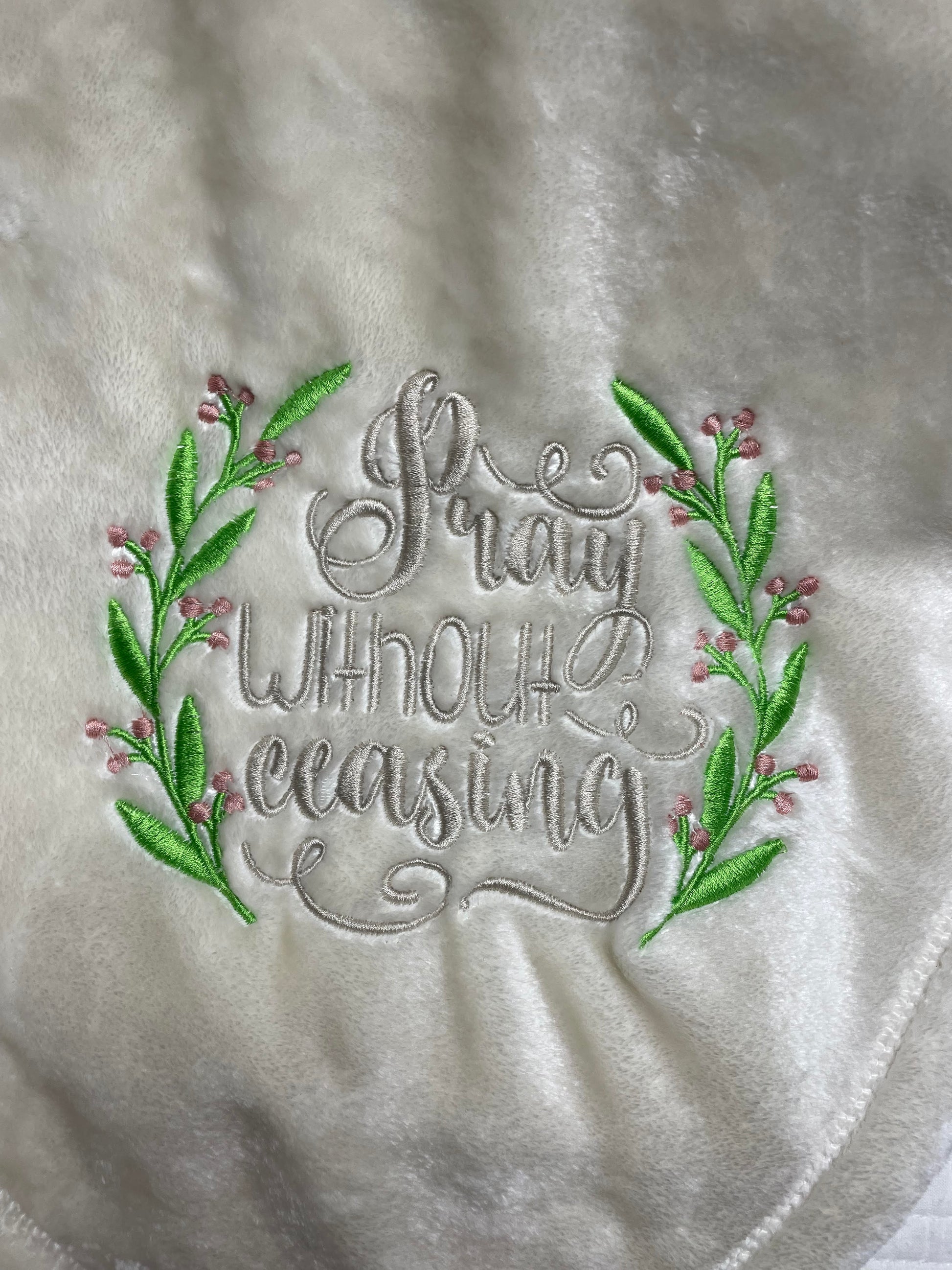 Blanket embroidered with the phrase Pray without Ceasing